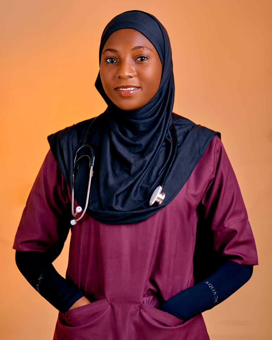Dr. Ayesha Khan, orthodontist at SmileCraft, smiling in teal scrubs